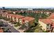 Aerial view showcasing a neighborhood with red-tiled roofs and lush landscaping at 1308 3Rd Street E Cir, Palmetto, FL 34221