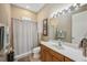 Standard bathroom featuring a light-colored vanity and shower with neutral curtain at 1308 3Rd Street E Cir, Palmetto, FL 34221