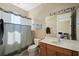 Comfortable bathroom with large mirror, updated vanity, toilet, and shower with curtain at 1308 3Rd Street E Cir, Palmetto, FL 34221