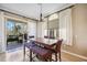 Dining room with a large wooden table, bench seating, and sliding glass doors to a balcony at 1308 3Rd Street E Cir, Palmetto, FL 34221