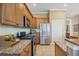 Well-equipped kitchen featuring stainless steel appliances, granite countertops, and ample cabinetry at 1308 3Rd Street E Cir, Palmetto, FL 34221