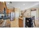 Modern kitchen with stainless steel appliances, granite countertops, tile floors and wood cabinets at 1308 3Rd Street E Cir, Palmetto, FL 34221