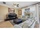 Bright living room with contemporary furnishings, ceiling fan, and a view of the balcony at 1308 3Rd Street E Cir, Palmetto, FL 34221