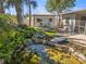 Backyard sanctuary with tranquil pond, seating, and charming shed at 1565 Saturn Rd, Venice, FL 34293