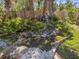 Beautiful backyard pond, lush plants, and stone pavers at 1565 Saturn Rd, Venice, FL 34293