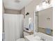 Bright bathroom with a shower, vanity, and a mirror, exuding a clean and refreshing ambiance at 1565 Saturn Rd, Venice, FL 34293