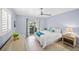 This light blue bedroom features a ceiling fan and sliding glass doors to let the sunshine in at 1565 Saturn Rd, Venice, FL 34293