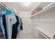 Spacious walk-in closet with ample shelving, hanging rods, and tiled flooring for organized storage at 1565 Saturn Rd, Venice, FL 34293