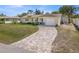Charming single-story home with well-manicured lawn and brick driveway at 1565 Saturn Rd, Venice, FL 34293