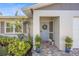 Charming front entrance with a paver walkway and lovely landscaping at 1565 Saturn Rd, Venice, FL 34293