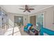 Screened lanai featuring comfortable seating and views of the lush backyard at 1565 Saturn Rd, Venice, FL 34293