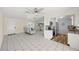 Living room adjacent to a modern kitchen featuring stainless steel appliances and granite countertops at 1565 Saturn Rd, Venice, FL 34293