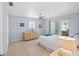 Bedroom with light blue walls, tile flooring, and access to an outdoor seating area at 1565 Saturn Rd, Venice, FL 34293