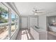 Office featuring a ceiling fan and large windows overlooking the backyard at 1565 Saturn Rd, Venice, FL 34293