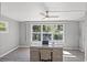 Bright office with a big window that overlooks a beautiful garden view and a modern glass desk at 1565 Saturn Rd, Venice, FL 34293
