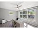 Office featuring a ceiling fan and large windows offering plenty of natural light at 1565 Saturn Rd, Venice, FL 34293