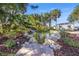Backyard oasis with a lush pond, waterfall, and colorful flowers at 1565 Saturn Rd, Venice, FL 34293