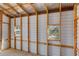 New shed under construction with wood framing and two windows allowing for an abundance of natural light at 1565 Saturn Rd, Venice, FL 34293
