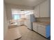 Bright kitchen featuring white appliances, cabinets, and tile flooring at 1613 Southwood St # 1613, Sarasota, FL 34231