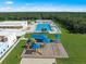 Aerial view of the playground and pool with a backdrop of lush green landscape at 16889 Lazzo Dr, Port Charlotte, FL 33953