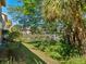 Lush backyard view with pond and community at 1718 Starling Dr # 104, Sarasota, FL 34231