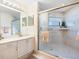 Bright bathroom featuring a walk-in shower with glass door, single vanity, and neutral tones at 1718 Starling Dr # 104, Sarasota, FL 34231