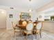 Elegant dining room with wood table and chairs, complemented by a stylish buffet at 1718 Starling Dr # 104, Sarasota, FL 34231