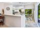 Cozy kitchen with white cabinetry, granite countertops, stainless steel appliances, and an eat-in area at 1718 Starling Dr # 104, Sarasota, FL 34231