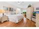 Serene main bedroom with a large bed, a cozy desk, and ample storage in a light, airy space at 1718 Starling Dr # 104, Sarasota, FL 34231