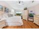 Comfortable main bedroom featuring a queen bed, wood flooring, lots of closet space, and a charming desk area at 1718 Starling Dr # 104, Sarasota, FL 34231