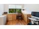 Functional home office with built-in shelving, an ergonomically designed chair, and natural light from the window at 1718 Starling Dr # 104, Sarasota, FL 34231