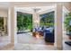 Cozy sun room filled with natural light, plush seating, and a view of the green outdoors at 1718 Starling Dr # 104, Sarasota, FL 34231
