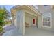 Inviting entrance with a cozy bench, decorative pillars, and a covered porch, providing a welcoming curb appeal at 1725 Riviera Cir, Sarasota, FL 34232