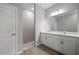 Stylish bathroom featuring a double vanity, quartz countertops, a tiled shower, and modern fixtures at 1806 Sunset Preserve Way, Port Charlotte, FL 33953