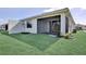 Spacious backyard featuring manicured lawn, a screened patio, and lush landscaping at 18821 Dayspring Pl, Venice, FL 34293