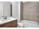 Bathroom with neutral-toned walls and flooring, a vanity, and a shower-tub combo at 18821 Dayspring Pl, Venice, FL 34293