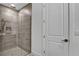 Modern bathroom featuring a frameless glass shower with gray tiled walls and a handheld shower head at 18821 Dayspring Pl, Venice, FL 34293