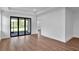 Open-concept living area featuring hardwood floors and sliding glass doors to the outdoors at 18821 Dayspring Pl, Venice, FL 34293