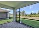 Screened-in lanai featuring stone pavers and an outdoor view at 18821 Dayspring Pl, Venice, FL 34293