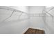 Bright walk-in closet with wire shelving, hardwood floors and white walls at 18821 Dayspring Pl, Venice, FL 34293