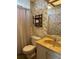Bathroom with vanity, toilet, medicine cabinet, and decorative wallpaper at 197 Palm Harbor Dr, North Port, FL 34287