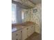 Bathroom featuring a vanity with a sink and mirror, and decorative wallpaper at 197 Palm Harbor Dr, North Port, FL 34287
