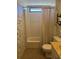 Bathroom featuring a tub with shower, toilet, and vanity with decorative wallpaper at 197 Palm Harbor Dr, North Port, FL 34287