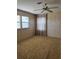 Bedroom features a ceiling fan, carpeted floor, and large windows with privacy curtains at 197 Palm Harbor Dr, North Port, FL 34287