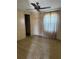 Cozy bedroom featuring a ceiling fan, closet, and window with coverings at 197 Palm Harbor Dr, North Port, FL 34287