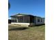 A clean exterior view of the mobile home showcasing the screened porch at 197 Palm Harbor Dr, North Port, FL 34287
