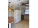 Cozy kitchen featuring white appliances, a hanging light fixture, and ample counter space at 197 Palm Harbor Dr, North Port, FL 34287