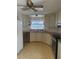 Well-lit kitchen with stainless steel appliances, bright lighting, and white cabinetry at 197 Palm Harbor Dr, North Port, FL 34287
