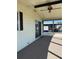 Covered porch features sliding glass doors and a ceiling fan at 197 Palm Harbor Dr, North Port, FL 34287