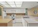 The kitchen offers white cabinets, tile floors, updated appliances, and plenty of counter space at 2320 Terra Ceia Bay Blvd # 406, Palmetto, FL 34221